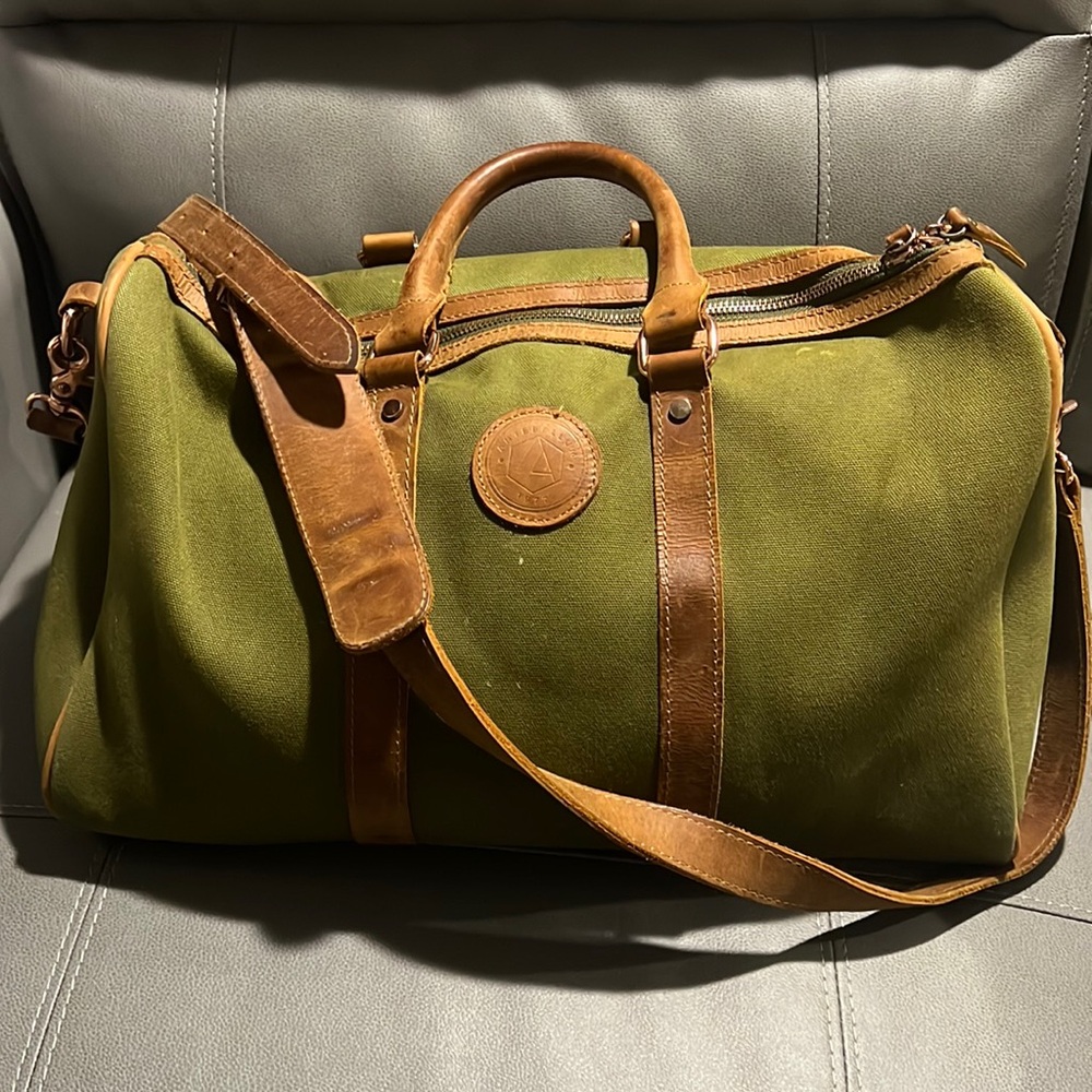 Weekend bag. good condition, lots of trips still left in it. Real leather trim.